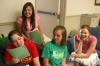 Rising Seniors Molly Merck, Katherine Givens, Chelse Lampley and Jessica Pikowski laugh as they decide on a plan of survival test they had been given. - Photo by Stephanie Schroeder