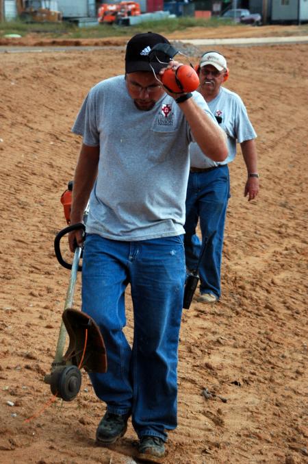 Matt Brasfiled walks away from weed-eating on Union's campus.