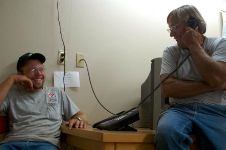 Matt Brasfield talks with Robert Cox, director of the grounds crew, at the close of a job.