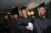 Smiling graduates prepare to march into the August graduation ceremony. - Photo by Morris Abernathy