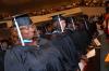 Education graduates spend time in prayer at the start of the August graduation ceremony. - Photo by Morris Abernathy