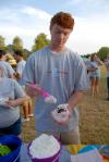 Tyler Jackson adds some whipped cream to his ice cream at the Ice Cream Social at President Dockery's home. - Photo by Morris Abernathy