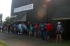 Approaching the opening hour of move-in, many families arrived to beat the heat and were lined up outside of Watters Commons as they waited to take their first steps towards moving into their dorms. - Photo by Stephanie Schroeder