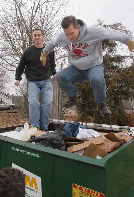 Ben Mandrell (left) and Mark VanderHaar give it their all while on clean up duty at The Care Center during Martin Luther King Jr. service day.