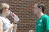 Emily Watlington talks with Andy Pettigrew as they take a break from helping freshmen move in during some of the hottest days of the summer. - Photo by Kathleen Murray
