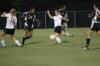 Junior Nikki Burau launches the ball upfield through a crowd of players. - Photo by Matt Elia