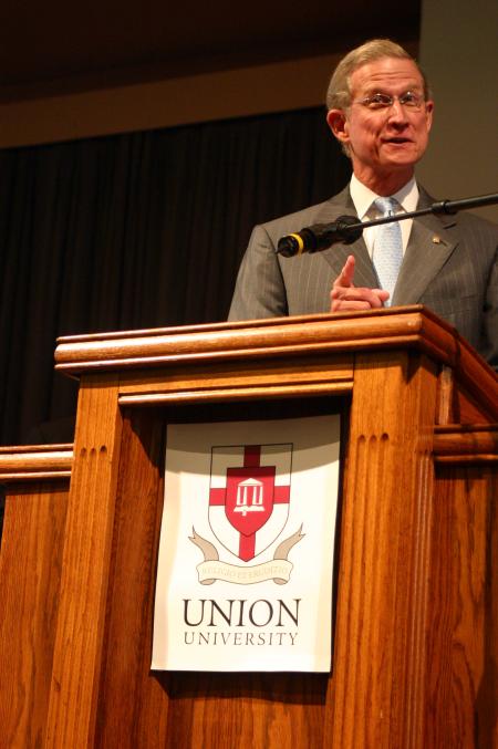 Stephen Reynolds, president and CEO of Baptist Memorial Health Care of Memphis, presents a check for $1 million to Union's health care programs at the beginning of a chapel service. 