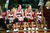 Freshman Jennifer Henson (11), Freshman Peggy McCain(21), Sophomore Laura Davison (15), and Sophomore Monica Elliot (24) look on from the bench. - Photo by Jim Veneman
