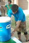 Junior Kieler Henry, DMS major, takes a break from the heat and helping move in to get some water provided by the SGA. - Photo by Matthew Diggs