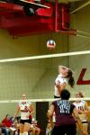 Junior Tiven Catrett goes up for the spike in a Union match versus Freed-Hardeman.  Union's CJ Neathamer (2) and Jennifer Martins (11) look on. - Photo by Matt Elia