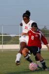 Freshman Eboni Murphy attempts to steal the ball from her Lyon College opponent.  - Photo by Neisha Fuson