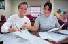 Freshmen Ashley Freeland and Cassie Badillo work together according to the newly implemented POGIL method to solve problems in Dr. Merkin’s chemistry class in White Hall. 
 - Photo by Matthew Diggs