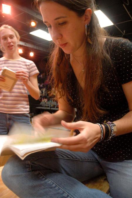 Senior Catherine Schulz flips through her script during a rehearsal for the play <em>The Dining Room</em>. 