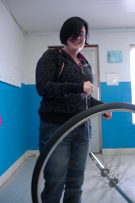 Michelle Thornhill demonstrates a principle of physics at a Boys and Girls Club. 