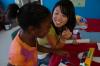 Sarah Kim explains rockets to a girl at the Boys and Girls Club where Union physics, chemistry and engineering students went to share some principles of science.  - Photo by Neisha Fuson