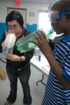 Michelle Thornhill demonstrates a physics experiment with a boy from a Jackson Boys and Girls Club. - Photo by Neisha Fuson