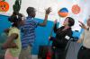 Michelle Thornhill gives a demonstration at the physics table at a Boys and Girls Club.  - Photo by Neisha Fuson