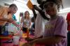 A girl from the Boys and Girls Club works on an experiment at one of the chemistry tables.  - Photo by Neisha Fuson