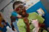 A girl from a Boys and Girls Club enjoys some strawberry ice cream just made by some chemistry students.  - Photo by Neisha Fuson