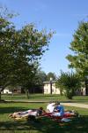 Sarah Brubaker and Hannah Williams sit outside with some friends as they enjoy the last few days of warm weather before the fall season comes. - Photo by Stephanie Schroeder