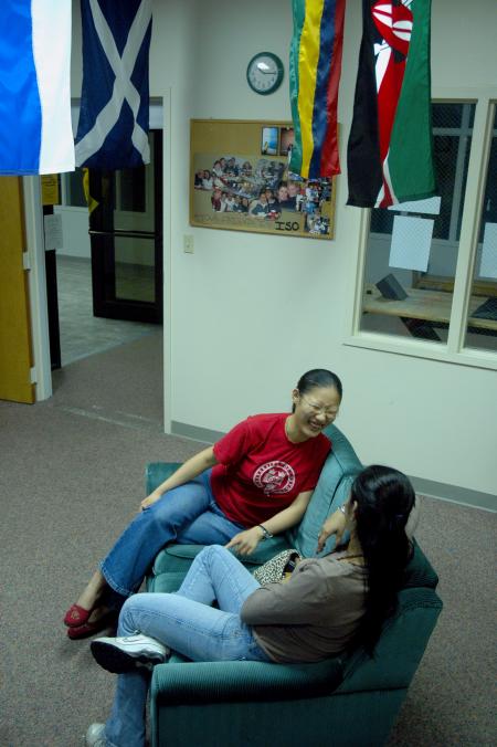 Senior Jasmine Huang laughs with M.A.I.S. Student Ariane Mansur in the international student lounge. 
