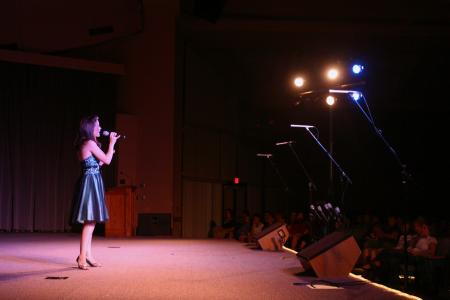 Victoria Green, emcee to All-Sing during Family Weekend, performs a solo number.