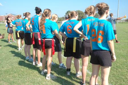 An independent flag football team prepares to take the field during Family Weekend.