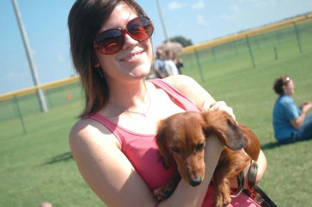 Beth Cruz enjoys the weather and an intramural flag football game while playing a friend's dog.
