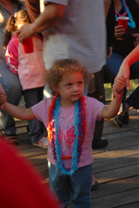 Armando's little sister dances in the group at the Make-A-Wish Foundation party. 