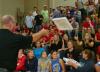 Union men's basketball coach Ralph Turner passes out pizza to the students during Bulldog Madness. - Photo by Stephanie Schroeder
