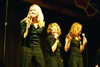Zetas Jamie Phillips, Amanda Raley, and April Stout belt out a number at All-Sing during Homecoming 2003. - Photo by Lindsay Stavish