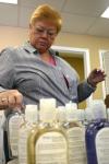 Phyllis Davenport sets out bottles of bath goods to be repackaged into gift bags for mothers at Birth Choice during Day of Remembrance. - Photo by Stephanie Schroeder