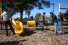 Freshmen Jessica Hall, Abby Parker, Rachel Pettigrew and Cherish Cooper rake wood chips to cover mud holes on a playground set at Whitehall Elementary School during Day of Remembrance. - Photo by Stephanie Schroeder