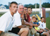 Jay Roberts, junior trainer; Bill Lean, father of Chris and Jeff Lean; Darin White, soccer coach and Kyle McDiarmid, junior midfielder, watch as the Bulldogs play Covenant College. - Photo by Kristen Hiller