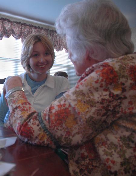 Freshman Claire Elmbald visits with a lady who lives at Cheyenne Trace on this year's Day of Remembrance. 