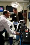 Mark Kossick demonstrates the technology in the simulation labs and lets alums test it out during the School of Nursing's homecoming reception. - Photo by Kristi McMurry