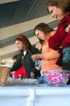 Guests at Homecoming's Arts in the Park browse at Rose Rogers's booth. - Photo by Kristi McMurry