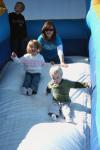 S.T.E.A. member Sarah Johnson supervises the inflatable slide during Homecoming's Arts in the Park. - Photo by Kristi McMurry