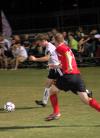 Senior Bulldog Benny Crozier drives past Lyon College’s Daniel Young. The Bulldogs shut out Lyon, 4–0. 
 - Photo by Matthew Diggs