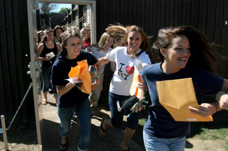 From right:Abby Parker, Hannah Lutz and Rachel Pettigrew dash through Hurt Commons on Sept. 15 to join with their new sorority sisters and completing rush week. Bid day continued with parties celebrating all the new members of the sisterhoods. 