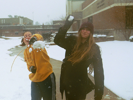 Sophomore Homecoming Maid Sarah Anderson and Junior Homecoming Maid Laura Lee Moore take time to have fun in the snow with friends.