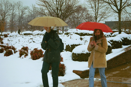 Seniors Erin Freshwater and Robin Armstrong walk cautiously to class in the unexpected snowfall.