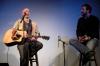 Taylor Worley gets to ask some questions of artist Jamie Barnes during a concert held in Barefoot's Joe for this year's Rounder's meeting.  - Photo by Neisha Fuson