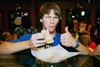 <i>Assignment: Friday Night at Bubba's Bagels:</i> Junior Jesse Florida, psychology major, eats a bagel while waiting in line to pay for it. He is also Greenwood’s drummer. - Photo by Justin Veneman