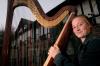 Anna Wicker displays her prized harp outside of its new home in The Jett. She now must store it in a separate room in The Jett and practices there. - Photo by Kyle Kurlick