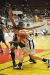 Sophomore Kaitlin Dudley drives to the basket against University of Science and Arts (Okla.)
during the first round of the NAIA national tournament. - Photo by Morris Abernathy