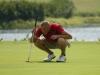 Clay Mallard lines up his put on the green. - Photo by Steven Aldridge