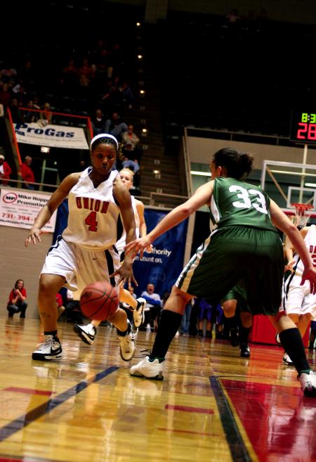 Jessica Graves dribbles past her University of Science and Arts opponent during the opening round of the NAIA Division I Women's Basketball National Championship at Oman Arena.  The Lady Bulldogs won the game 95-66.