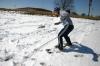 Snow covered Union's campus the night of Mar. 7, and students took a break from studying to play in it. Sophomore Leah Heinsch tries to snowboard by the soccer fields. - Photo by Stephanie Schroeder