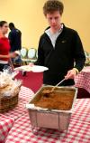 Brock Starnes, junior management major, gets a barbeque plate in Coburn.  The delicious barbeque lunch was provided and prepared by the team members at Gwatney Chevrolet in Memphis, TN.  - Photo by Kristi McMurry